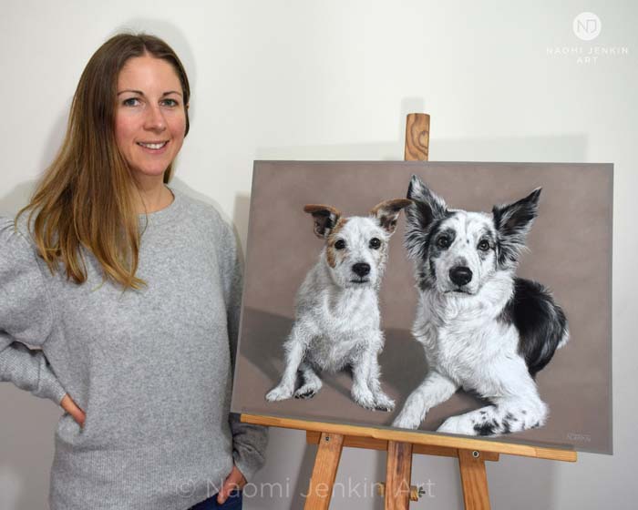 Pet portrait artist Naomi Jenkin with pastel dog portrait of Cotton and Bella.